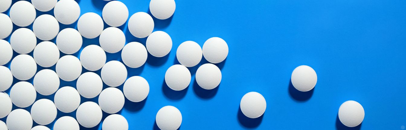 White pills on a blue background.