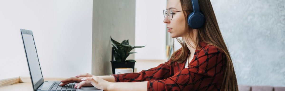 A woman typing on a laptop.