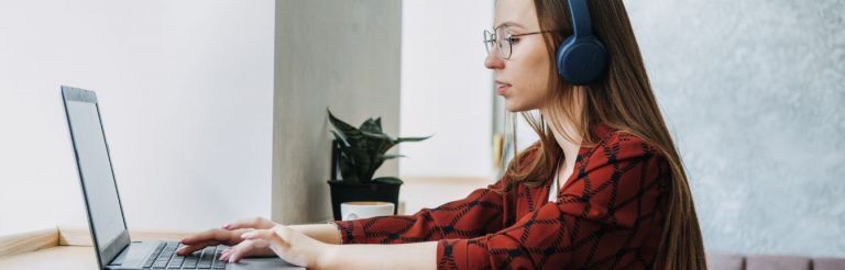 A woman typing on a laptop.