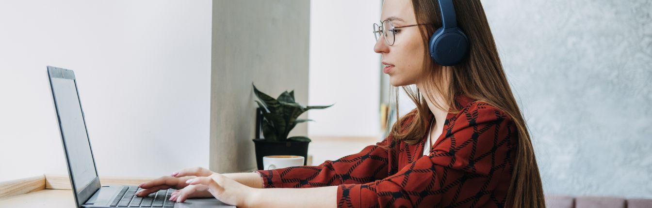 A woman typing on a laptop.
